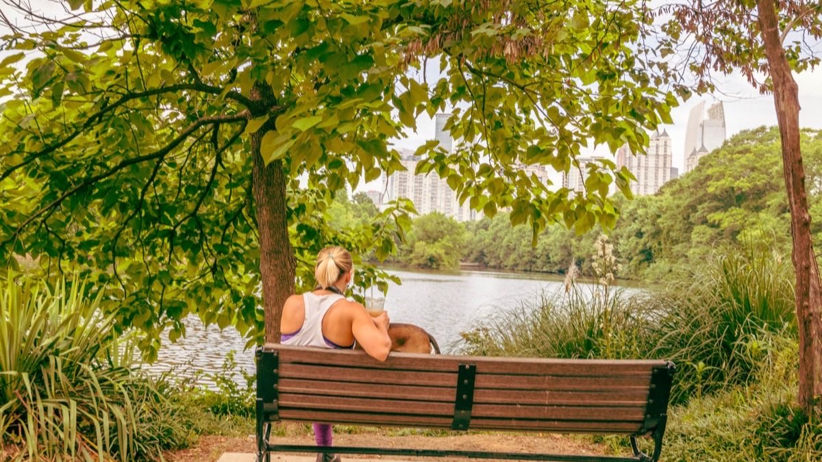Persona descansando en una banca del parque durante una caminata